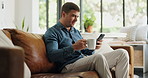 Man, freelancer and phone with coffee at house for real estate, property research and listing. Realtor, reading and beverage with mobile, email client and viewing information for resale negotiation