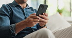 Typing, connection and hands on couch with phone, post reaction and communication on email platform. Digital, texting and man in house with tech, social media update and message on online app