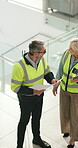 Architect, team and talking with blueprint in building for renovation design, inspection or above. Pointing, mature people and floor plan on site for commercial development, office remodeling or tech