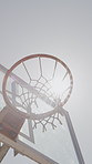 Fitness, sunshine and net outdoor for basketball, hoop fabric and equipment for practice session. Low angle, flare and ring setup on court for summer activity, rim and game training in sports hobby.