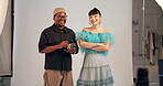 Camera, face and smile of model with photographer in studio for fashion catalog or magazine. BTS, photography or production with man and woman on set together for creative media or style session