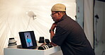 Photography, review and tablet screen with black man in studio for image selection of magazine shoot. Choice, display and picture with photographer bts on set for decision, fashion catalog or results