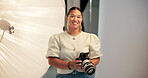 Face, woman and photographer in studio with camera, pride or entrepreneurship for creative career. Happy, person and confident in workplace with photography equipment, media production or photoshoot.