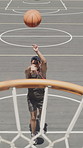 Sports, basketball and teenager shooting on court for score, competition or training with low angle. Player, boy and throw ball in hoop for fitness, exercise and practice for game with goal outdoor