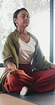 Calm, woman and meditation with lotus on yoga mat for spiritual wellness, zen or healing in home. Female person, relax or breathing with inner peace for mindfulness, awareness or chakra balance