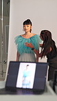 BTS, photography and styling with model in studio for advertising campaign or fashion magazine. Clothes, getting ready or photoshoot with stylist and woman on set for catalog or production session