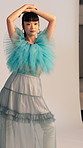 Asian woman, media and model with photoshoot for fashion, production process and picture. Photography, style and person with glamour on set, magazine catalog and behind the scenes in creative studio
