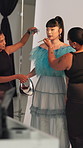 BTS, photoshoot and styling with woman in studio for advertising campaign or fashion magazine. Getting ready, handbag or photography with model and stylists on set for catalog or production session