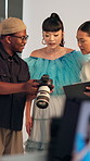 Camera, studio and talk to people for photography, show picture or bts for fashion feedback. Production, team and conversation on set with creative direction, review image or planning with clipboard
