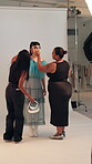Fashion, photography and stylist with model in studio for bts shooting, magazine and ecommerce catalog. Photoshoot session, designer clothes and behind the scenes with people on set for project