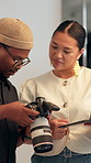 Camera, laptop and photographer talking to director in studio for feedback, results or review. Computer, conversation or photography with man and woman on set for discussion or production ideas