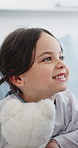 Healthcare, kid and girl in hospital bed, smile and recovery with happiness, healing and wellness. Patient, medical service or child in clinic, teddy bear for comfort or listening to positive results