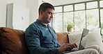 Laptop, freelancer and research with man on sofa for blog writer, virtual editor or newsletter promotion. Online magazine article, remote worker and email marketing with person in living room of home