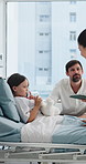 Dad, girl and doctor on tablet at hospital bed with talk, report and update for recovery with illness. People, pediatrician and father with child patient, tech or app for healing process at clinic