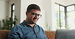 Laptop, freelancer and glasses with man on sofa for blog writer, virtual editor and newsletter promotion. Online magazine article, remote worker and email marketing with person in living room of home