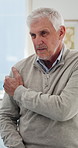 Clinic, conversation and old man in appointment with shoulder pain, osteoporosis or explain symptoms. Hurt, senior person and talk in medical center with joint inflammation, discomfort or healthcare.