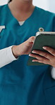 Hands, doctor and typing with tablet at hospital in lobby, checklist and notes for wellness report. Person, tech and medical professional for telehealth, application or click with review at clinic