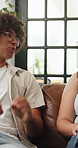 Conversation, relax and couple on sofa in home with communication, bonding or love together. Happy, talking and people for advice or gossip in living room for connection in relationship at house.