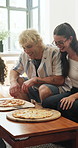 Happy, celebration or friends in living room with pizza, food party or bonding together in reunion. Social gathering, lunch or people in home with eating, relax or shared meal in healthy relationship