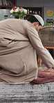 Folding, prayer mat and Muslim man in home for spiritual worship, faith and praise in Ramadan. House, culture and Islamic person done with salah, dua and religious practice for belief or devotion
