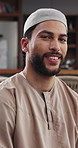 Face, smile and muslim man in home for relax, peace and calm with faith on Ramadan Kareem. Portrait, house and Arab person with culture, islamic tradition and religion in living room in Oman
