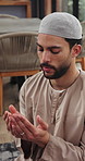Muslim man, praying and hand together with dua for worship, faith or spiritual connection in home. Islam, male person or blessing with islamic belief, holy religion or praise god for forgiveness