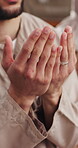 Muslim, man and hands in home with prayer, spiritual belief and worship Allah for Ramadan Kareem. Islamic person, religious and salah in apartment with peace, gratitude and dua for connection to God.
