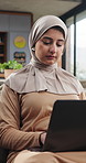 Remote work, laptop and Islamic woman on sofa, research for news report and reading at home. Apartment, freelancer and Muslim person on couch, computer and connection for article editing and network
