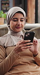 Home, muslim and woman with phone, relax or scroll app with comment on social media. Mobile, islam and happy person in living room for internet search, check notification or online news in house