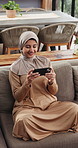 Home, sofa and muslim woman with mobile, relax or streaming service with video on internet. Phone, islamic and happy person in living room to watch film, online series and show with movie in house
