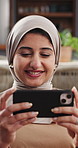 Home, muslim and woman with mobile, relax or streaming service with video on internet. Phone, islamic and happy person in living room to watch film, online series and show with movie in house