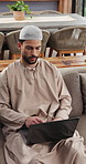 Muslim, man and remote work in home with laptop, research or typing news report for journalism job. Freelance, writer or Islamic person on sofa with computer, thinking or deadline for online article.