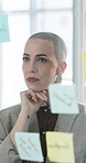 Thinking, glass wall and businesswoman in office with planning for creative project at startup. Sticky notes, board and female magazine editor with brainstorming for article publishing at agency.