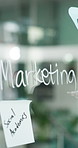 Glass, writing and business person with marketing for social media campaign, planning and brand strategy. Creative, office and worker with sticky notes, agenda and brainstorming for project ideas