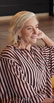 Thinking, senior woman and relax in home, retirement and calm on break, daydream and happy on couch. Pensioner, reflection and elderly person with smile on weekend, wellness and wonder in apartment