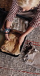 Suitcase, packing or woman with clothes on floor, vacation preparation or travel wardrobe organization. Above, luggage or mature person sorting for holiday, home or getting ready for abroad flight