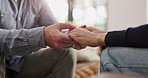 Holding hands, comfort and couple in home for love, care or bonding together in living room. Trust, empathy and people for connection with commitment, hope or marriage with compassion in apartment.