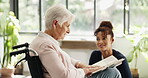 Volunteer, book or old woman with wheelchair in nursing home, novel discussion or retirement hobby. Community service, happy helper or senior person with disability in hospice, story summary or chat