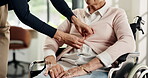 Hands, help and nurse dressing old woman in wheelchair for assisted living, healthcare or support. Buttons, getting dressed and senior patient with disability in nursing home for medical assistance