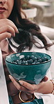 Hands, woman and blueberry in home with diet, organic produce or detox for self care on sofa. Person, relax and eating snack with fruit for benefits, nutrition and antioxidants on couch at apartment