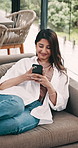 Woman, smile and relax in home with phone, social media and notification for dating app on weekend. Happy, person and browsing on sofa with tech, text message and network for digital communication.
