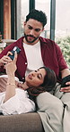 Couple, relax and conversation on sofa with phone for social media, online news or bonding together. Married people, talk and tech in home for browsing internet, connection or chill on weekend break.