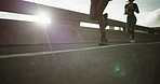 Legs, women and running in city for fitness, exercise and friends workout with low angle. Bridge, shoes and runners training outdoor for health, cardio endurance and people jog together with flare