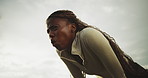 Tired, black woman and breathing for fitness outdoor with burnout, exercise challenge and break. Low angle, exhausted and female person with fatigue, intense training and recovery from sports workout