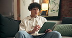 Remote work, surprise and tablet with man on sofa in living room for online planning or research. App, reaction and revew with happy employee in home for small business freelance or startup career