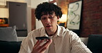 Breathing, phone call and stress with man in living room of home for feedback or serious discussion. Anxiety, thinking and voice note with person on sofa in apartment for ideas, planning or solution