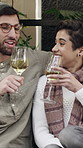 Wine, cheers and couple outdoor at restaurant for date on holiday with bonding, care or marriage. Happy, conversation and man with woman for drinking alcohol beverage on vacation together at cafe.