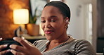 Watching, online and black woman with phone on sofa for online videos, streaming and internet. Surprise, home and person on smartphone with reaction for series, entertainment and subscription on app