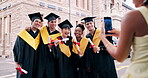 Graduation, smile or students with photography on campus, college milestone or celebration memory. Picture, phone or happy people with scroll of academic success, education development or achievement