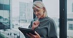 Design, review and tablet with business woman in office for management, planning or research. App, reading and thinking with mature designer in city workplace for development or digital agenda